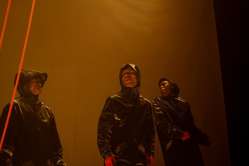 3 figures in rain suits